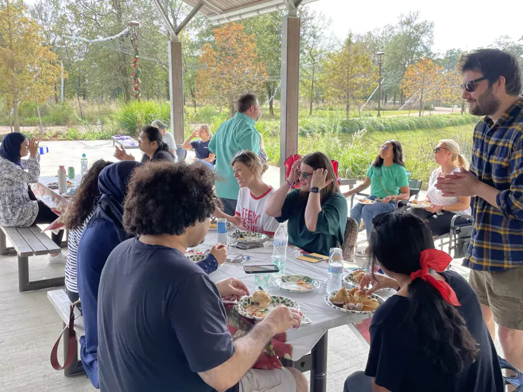 Kahuna team members talk and eat at the 2021 Holiday Potluck