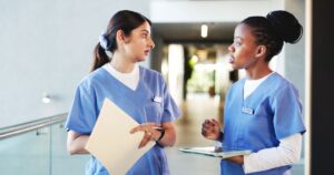 nurse with paper and nurse with tablet for hospital competency tracking