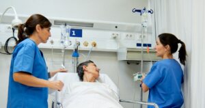 Nurses attending to a patient in hospital for a transition-to-practice program assessment