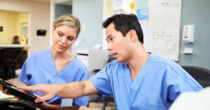 Two nurses discussing ptap accreditation programming together
